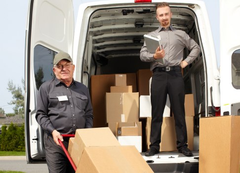 Loading furniture into a removals van near Monken Hadley