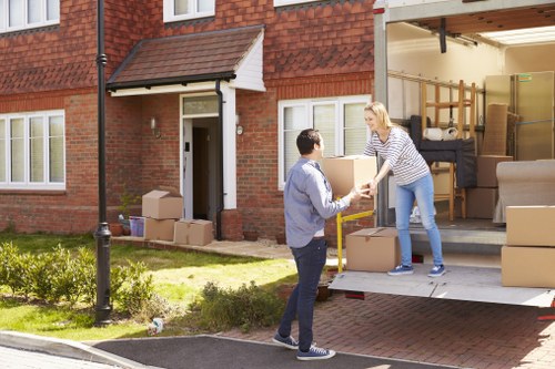 Professional removals team handling furniture in a residential street