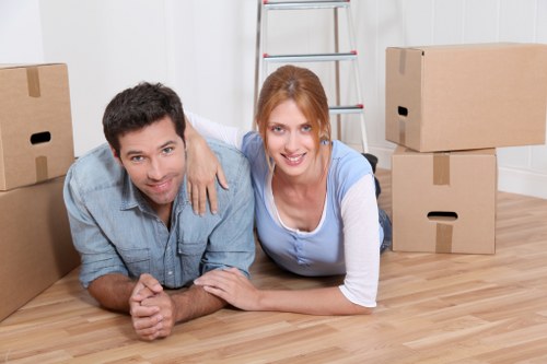 Professional movers handling furniture in a village property